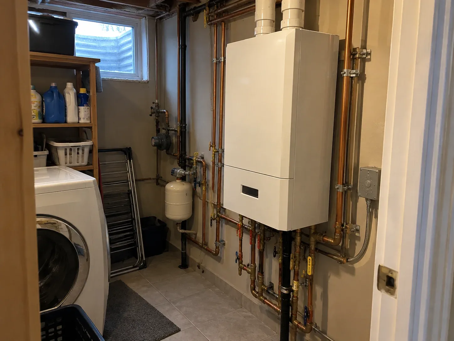 Wall-mounted residential combi boiler installed in a Hamilton basement